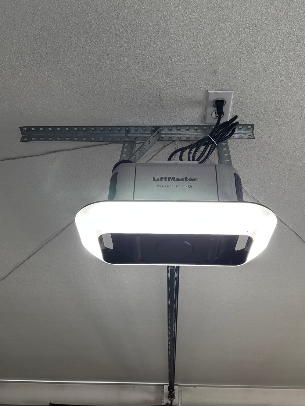 LiftMaster garage door opener mounted on ceiling with bright LED light feature.