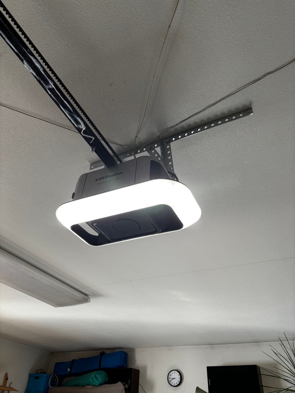 LED garage door opener mounted on ceiling, featuring a modern design and integrated light.