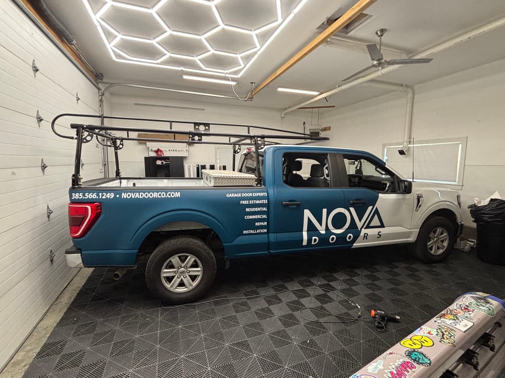 NOVA Doors service truck parked in a garage, equipped for garage door installation.