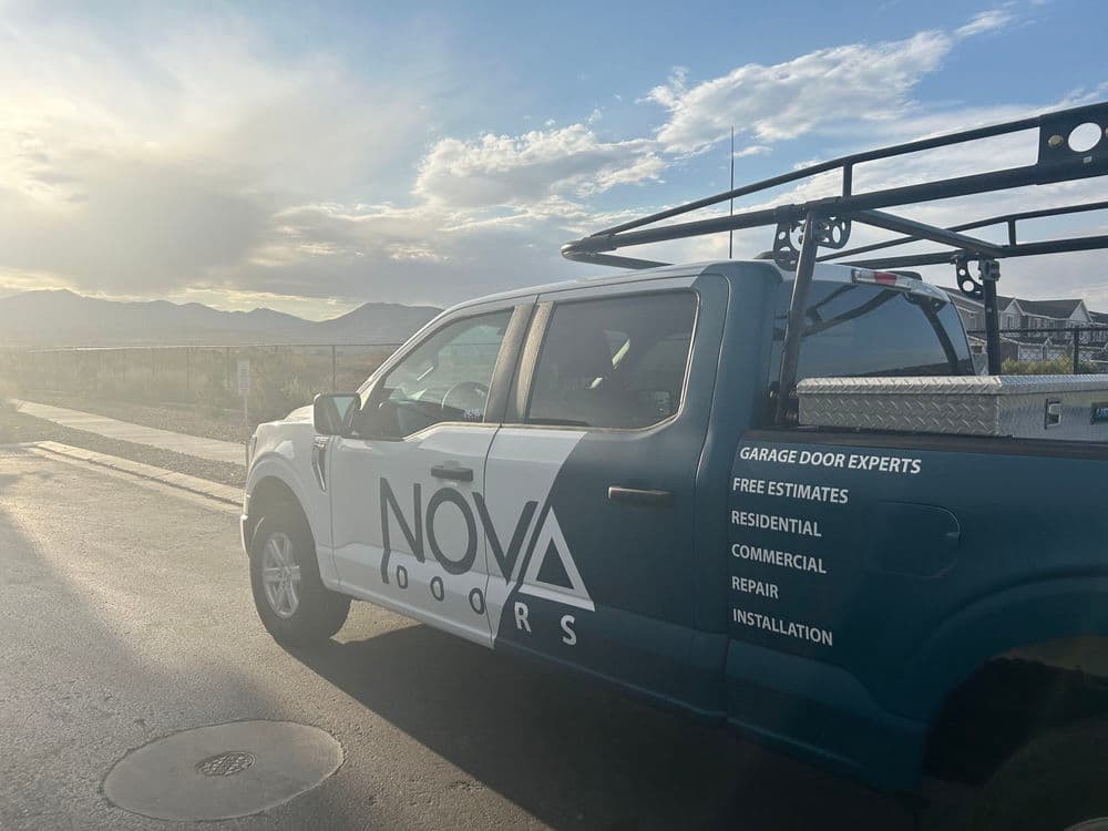 Nova Doors truck parked with mountains in the background, showcasing garage door services.